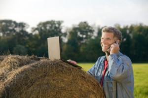 Guy on the phone on a haybale